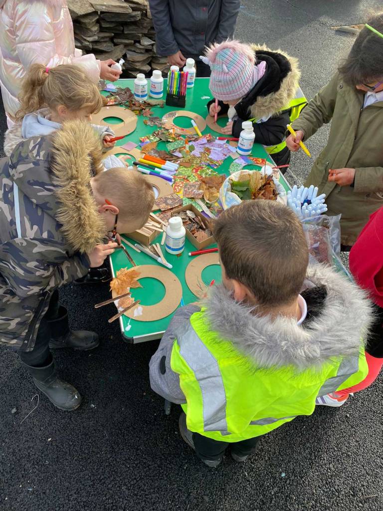 A group of young children learning to make autumnal wreaths at Growchapel Community Garden