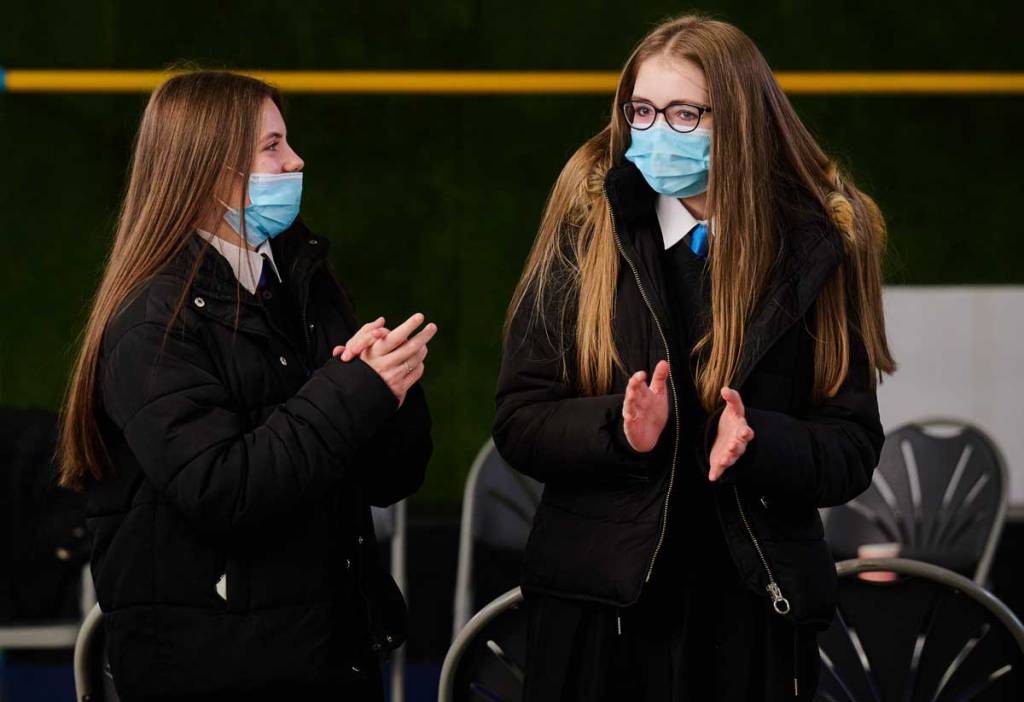 School pupils wearing masks taking part in a partnership session with youth workers