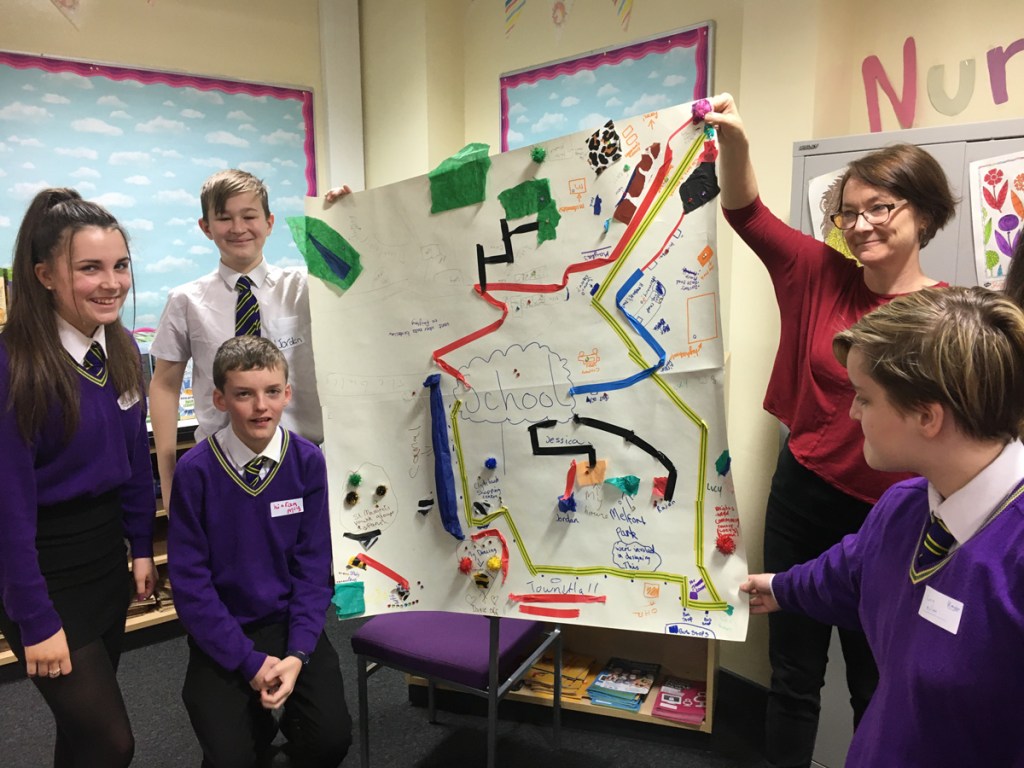 A group of young co-researchers and a CNS researcher present a poster during a Capabilities workshop